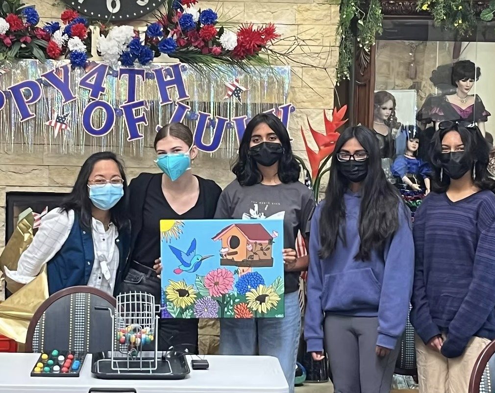 CARES officers holding the painting at Gordon Manor