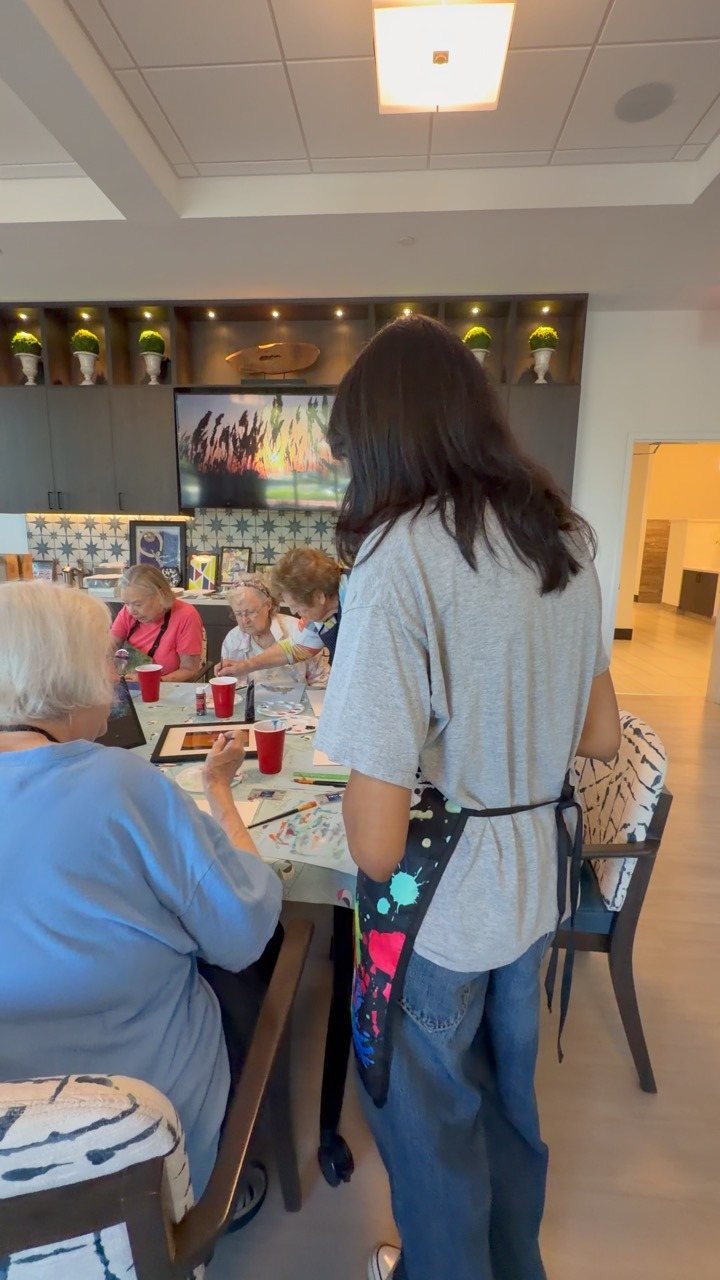 A CARES volunteer helping a resident paint