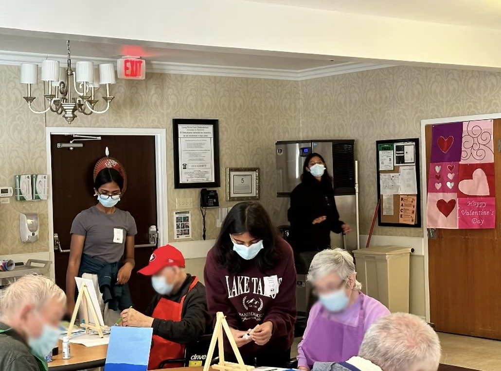 CARES officers helping residents paint at tables